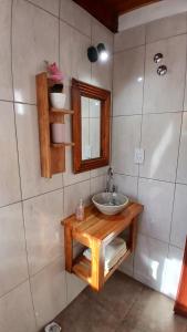 a bathroom with a sink and a mirror at Los Nenúfares in Lago Puelo +5 photos