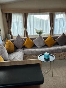 a living room with a couch with yellow pillows at Murphys in Brigham