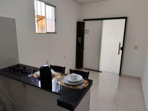 a kitchen with a table with a plate on it at Apartamento central - Feijó 01 in Vitória da Conquista +1 photo