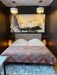 een slaapkamer met een bed met een schilderij aan de muur bij Karula Stay - 2 Room City Centre Apartment in Antsla