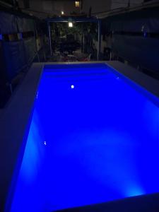a blue swimming pool in a dark room at Terranova in Capilla del Monte
