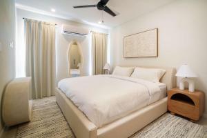 a bedroom with a large bed and a mirror at Elegant LUX 2BR 3mins to Beach Pool & Deck in Saint James