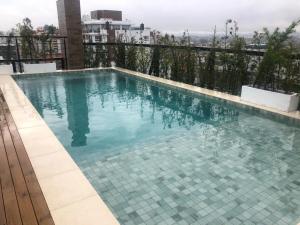 a swimming pool on top of a building at Baltico302 in Capão da Canoa
