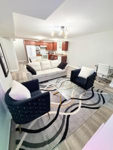 a living room with two chairs and a couch at True Haven Deluxe in Prince George