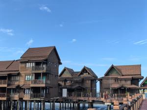 a row of houses on a dock on the water at Langkawi Lagoon Floating Resort 02 in Langkawi Intl