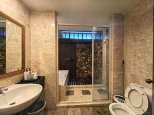 a bathroom with a shower and a sink and a toilet at Langkawi Lagoon Floating Resort 02 in Langkawi Intl +59 photos