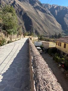 a road with a mountain in the background at Lavanda lodge Ollantaytambo in Ollantaytambo