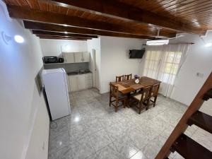 an overhead view of a kitchen with a table and refrigerator at Eucalipto Dúplex in San Vicente +9 photos