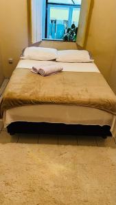 un letto grande con due cuscini e una finestra di Casa63 a Lençóis