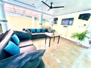 a living room with a couch and a table at La Roma - Hot Spring Private Resort in Pansol