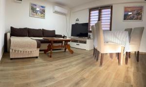 a living room with a couch and a table at Apartmani Fenix 29 in Ljubovija