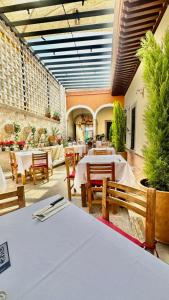 a restaurant with tables and chairs in a building at Casona Bartolome in Morelia