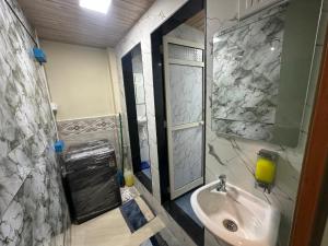 a bathroom with a sink and a window and a sink at Goldsport Dormitory in Jāmb +2 photos