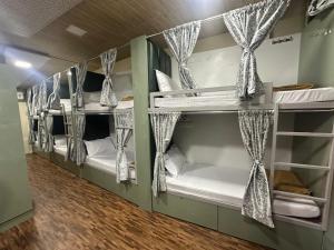a room with four bunk beds in a room at Goldsport Dormitory in Jāmb