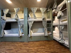 a room with bunk beds in a dorm room at Goldsport Dormitory in Jāmb