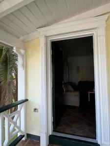 a door leading to a living room with a couch at The Palms apt 2 in Cedar Grove