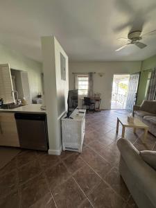 a kitchen and living room with a couch and a table at The Palms apt 2 in Cedar Grove