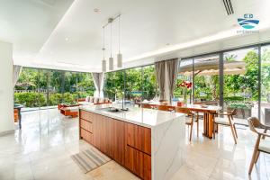 an open kitchen and dining room with a table and chairs at Astana Villa Non Nuoc Beach in Da Nang