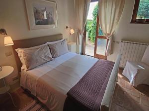 a bedroom with a large bed and a window at Modern holiday home in Foligno - Loc with pool in Case Vecchie