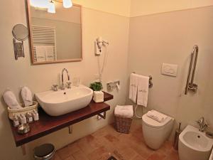 a bathroom with a sink and a toilet and a mirror at Modern holiday home in Foligno - Loc with pool in Case Vecchie +32 photos