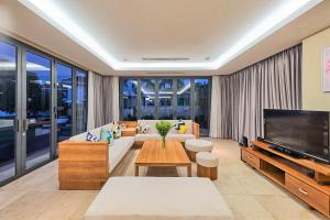 a living room with a couch and a tv at Astana Villa Non Nuoc Beach in Da Nang