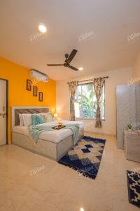 une chambre avec un lit et un ventilateur de plafond dans l'établissement En-Ocean Luxurious Infinity Pool Villa Overlooking Sea And Beach Touch, à Alibaug
