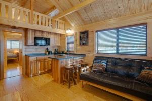 a living room with a leather couch and a kitchen at Angel Fire RV Resort in Angel Fire