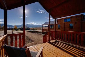 a porch of a cabin with a view of the mountains at Angel Fire RV Resort in Angel Fire