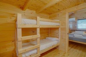 a bedroom with two bunk beds in a log cabin at Angel Fire RV Resort in Angel Fire +1 photo