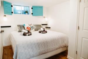 two stuffed teddy bears sitting on a bed at The Bay Crib in Ottawa +38 photos
