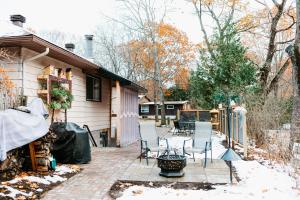a patio with chairs and a table in front of a house at The Bay Crib in Ottawa