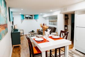 a dining room and living room with a table and chairs at The Bay Crib in Ottawa