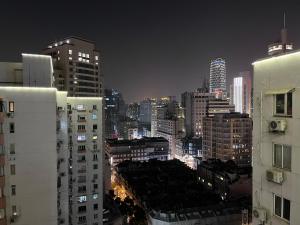 a city skyline at night with tall buildings at 上海Zighouse人民广场店 People's Square Branch, Shanghai in Shanghai