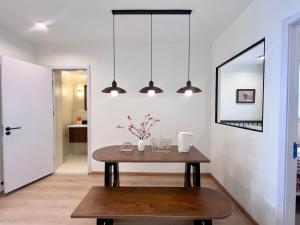 a dining room with a table and pendant lights at 上海Zighouse人民广场店 People's Square Branch, Shanghai in Shanghai