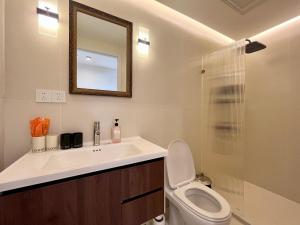 a bathroom with a sink and a toilet and a mirror at 上海Zighouse人民广场店 People's Square Branch, Shanghai in Shanghai +16 photos