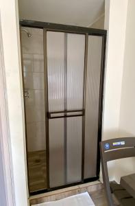 a shower stall with a glass door in a bathroom at Best View Aparta Hotel in Dosquebradas