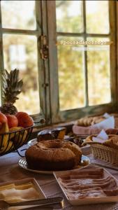 a table topped with plates of bread and other foods at Pousada Sossego in Lavras Novas +10 photos