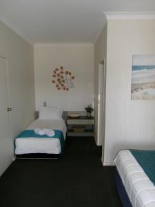 Postel nebo postele na pokoji v ubytování Caravilla Motor Inn