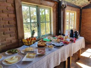 a table with a bunch of food on it at Pousada Sossego in Lavras Novas