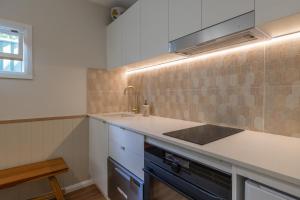 a kitchen with a sink and a counter top at Hibiscus Cottage in Ballina +4 photos