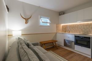 a living room with a couch and a table at Hibiscus Cottage in Ballina