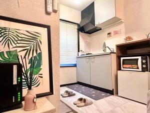 two pictures of a kitchen with shoes in a room at Mori de house in kobe 1 in Kobe