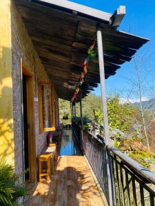 a balcony of a house with flags on it at The Link farmstay in Sa Pả