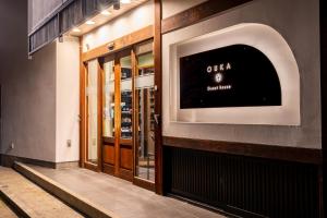 a store front with a sign on the side of a building at Guest House Ouka in Takayama