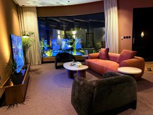 a living room with a couch and a table at Cali chalets in Riyadh