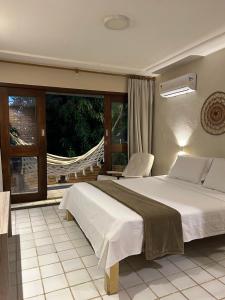 a bedroom with a large bed and a window at Casa do Luar I Alagoas I Nordeste-Coruripe in Coruripe +31 photos