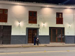 a man and a child walking in front of a building at Redys House in Cusco