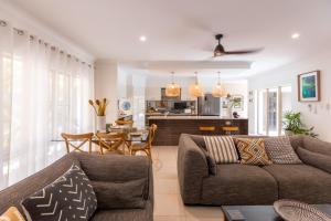 a living room with a couch and a table at Escapades @ Palm Cove in Palm Cove