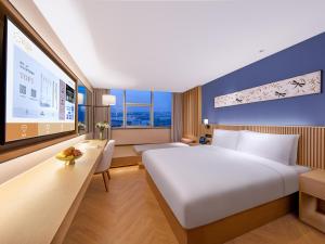 Giường trong phòng chung tại Orange Crystal Hotel Nanjing Drum Tower +31 ảnh