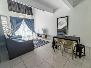 a living room with a table and a couch at De Centrum Residences in Kajang